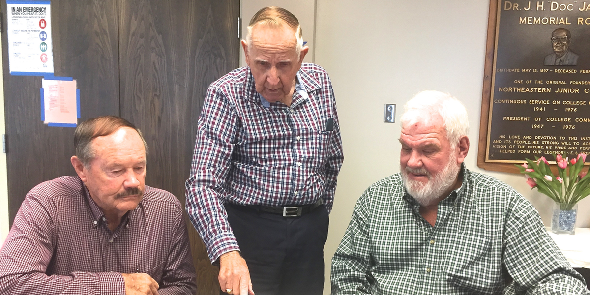 n the photo is Jack McLavey (left), Jack Annan (center) and Tom Hastings looking through the 1964 NJC yearbook.
